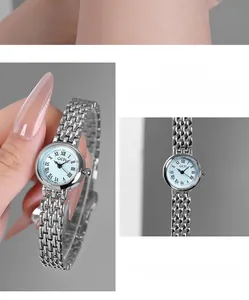 Detail of GEDI small green dial watch with Roman numerals and silver steel strap