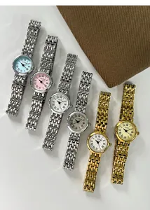 Detailed top view of GEDI quartz watches with colorful dials and stainless steel bands