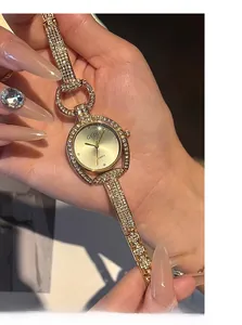 Detailed macro view of GEDI gold luxury watch band with sparkling crystals and dial