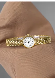 Close-up of GEDI vintage gold steel watch with Roman numerals and elegant metal strap