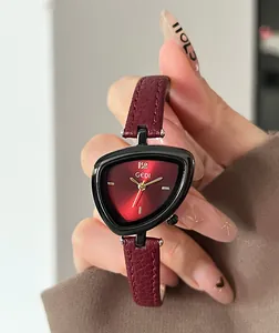 Detailed shot of a triangle quartz watch with a red sunburst dial and leather strap