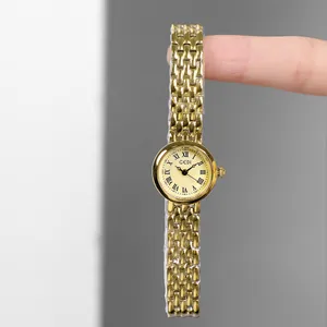 Elegant gold-tone women's quartz watch with small round dial and metal chain strap