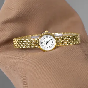 Elegant gold stainless steel women's quartz watch with white Roman numeral dial