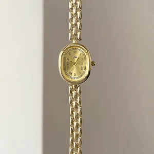 Vertical view of gold oval vintage watch with Roman numerals and multi-row chain band