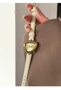 Detailed view of the unique triangle watch dial and off-white leather litchi grain strap