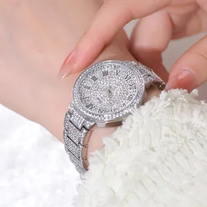Macro shot of silver women's quartz watch with sparkling diamonds and Roman numerals