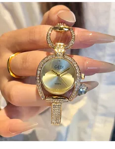 Close-up of gold GEDI watch with rhinestone bezel and jewelry-style bracelet