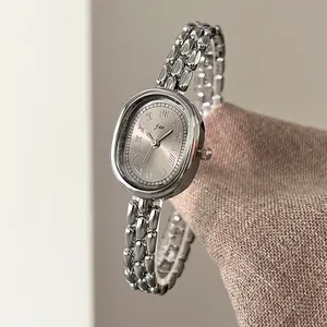 Vintage oval silver metal women's watch with Roman numerals and multi-row bead chain