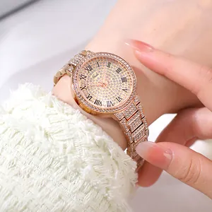 Close-up of rose gold luxury watch for women with sparkling rhinestones and Roman numerals