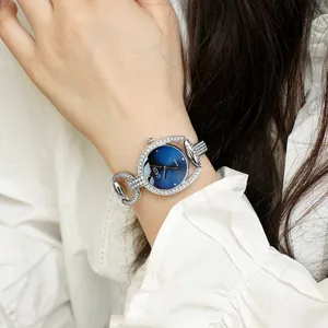 Elegant silver bracelet watch with a starry blue dial and sparkling rhinestones for women