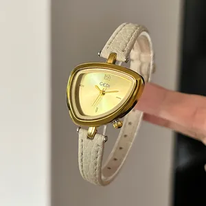 Minimalist irregular triangle quartz watch with gold metal dial and beige leather strap