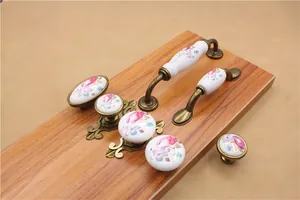 Detail of floral ceramic handles with antique bronze base for cabinets and drawers