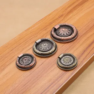 Macro view of four antique bronze sunflower ring handles in small and large sizes