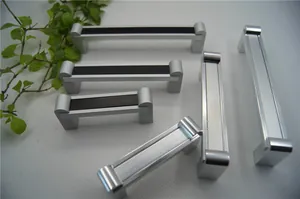 Details von silbernen Aluminium-Möbelgriffen in verschiedenen Längen auf weißer Struktur