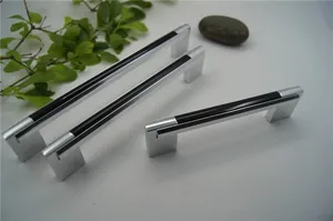 Detail showing two sizes of modern black and silver U-shaped aluminum cabinet handles