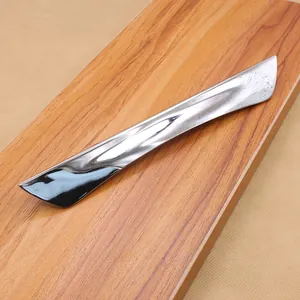 Polished chrome alloy drawer handle with sleek recessed design on wooden board