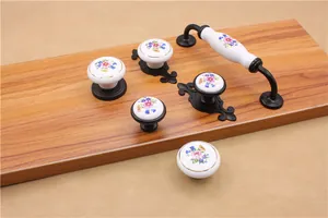 Floral pattern on white ceramic cabinet pulls with black metal base for drawer decor