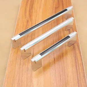 U-shaped silver cabinet handles with black inlay in three sizes on wood background