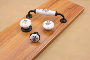 Detail of floral ceramic cabinet handles with vintage hand-painted blue flowers