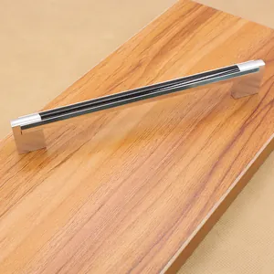 Close-up of a modern silver and black aluminum door handle on a textured wood surface