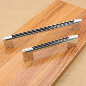 Macro shot of silver aluminum cabinet handles with black trim in two different lengths