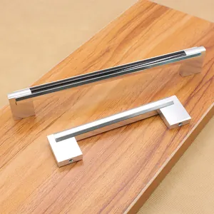 Detailed view of modern silver and black U-shaped aluminum alloy cabinet handles on wood