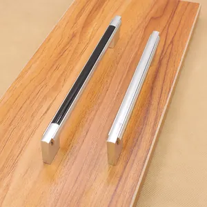 Modern black and silver aluminum alloy U-shaped cabinet door handles on wood surface