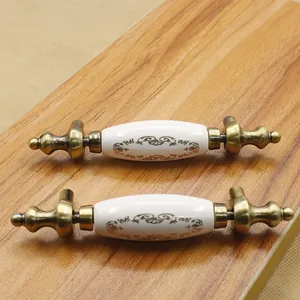Detail of vintage European drawer handles with floral ceramic and antique brass finish