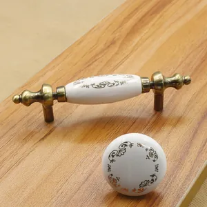 European antique white ceramic cabinet handles with gold vine patterns and bronze bases