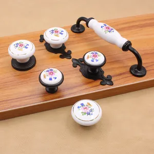 European style white ceramic cabinet handles with colorful floral patterns and black bases