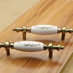 Close-up of antique bronze zinc alloy furniture handles with floral ceramic inlay
