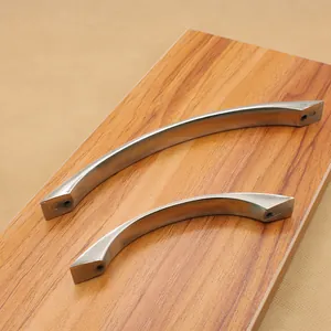 Brushed silver aluminum arc-shaped cabinet handles on wooden texture surface