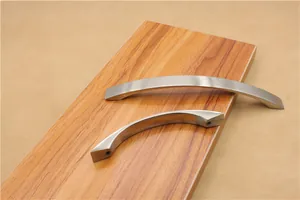 Macro detail of curved aluminum alloy cabinet handles with brushed silver finish texture