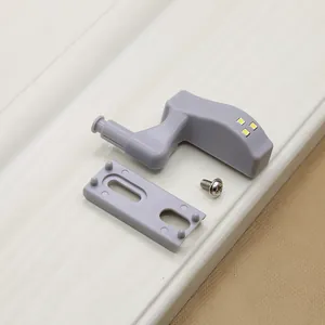 Detail view of the LED cabinet hinge light kit including lamp body, base, and mounting screw