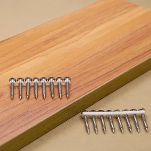 Macro detail of row-connected stainless steel self-tapping screws on wooden surface