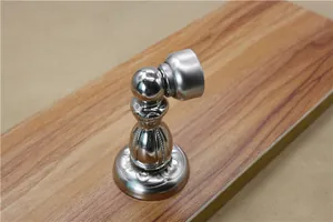 Detail of vintage European style magnetic door stopper with floral relief patterns
