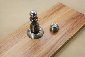 Antique bronze magnetic door stopper with elegant brushed finish and carved details