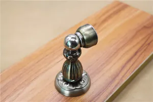 Detail of antique bronze magnetic door stopper with European embossed decorative patterns