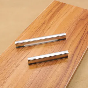 Macro detail of brushed silver aluminum drawer handles with a modern J-shape design