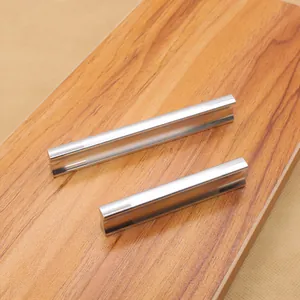 Modern brushed aluminum cabinet handles in two sizes displayed on a wooden texture background