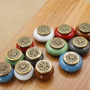 Detailed view of floral engraved ceramic cabinet knobs in various vintage colors