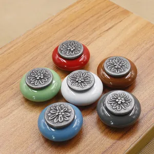 Detailed view of floral relief ceramic knobs in antique silver and varied colors