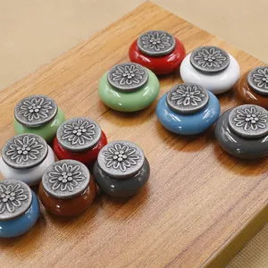 Macro detail of antique floral ceramic knobs in vibrant colors for drawer decoration