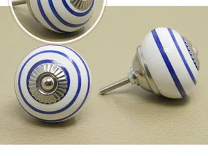 Macro detail of round ceramic cabinet knob with blue swirl pattern and metal base