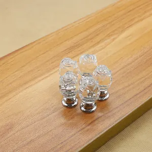 Detailed view of tulip-shaped crystal glass drawer knobs with polished metal base
