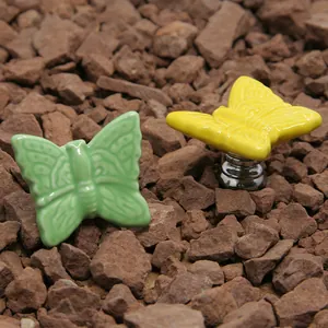 Ceramic butterfly drawer knobs in green and yellow with polished metal base