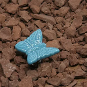 Close-up of sky blue butterfly ceramic cabinet handle with detailed 3D embossed wings