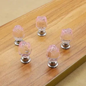 Macro detail of five rose-shaped pink crystal furniture knobs with silver metal bases