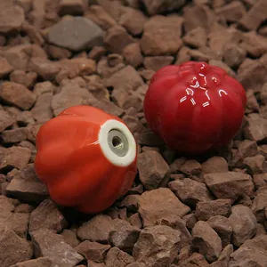 Polished pumpkin ceramic cabinet handles in red and orange with metal mounting base
