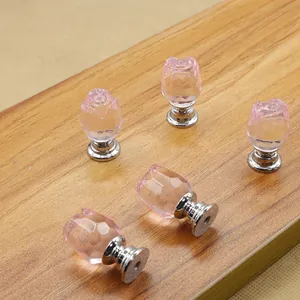 Close-up of pink rose-shaped crystal knobs with silver metal base for cabinets